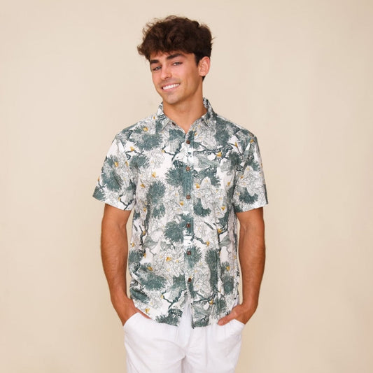 Model wears Kaniakapūpū Lehua Green on White Men's Dress Shirt