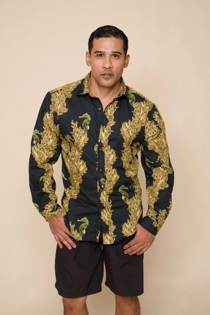 Man wears black and gold Mens long-sleeve Aloha Shirt